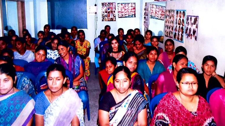 Women gathered at a village community meeting