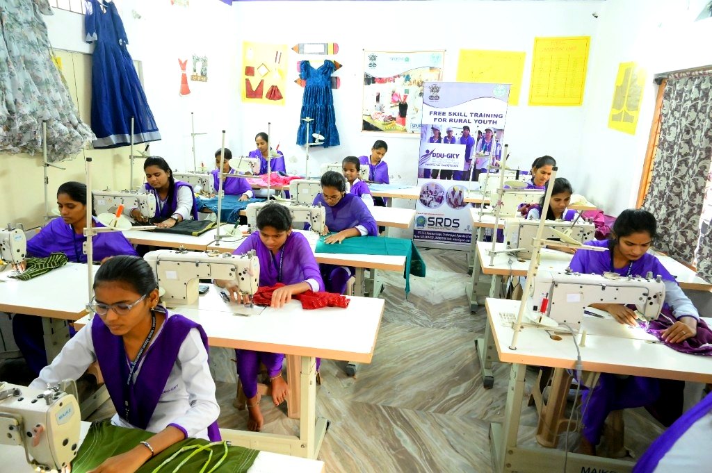 Women trainees at sewing machines in a tailoring skill centre